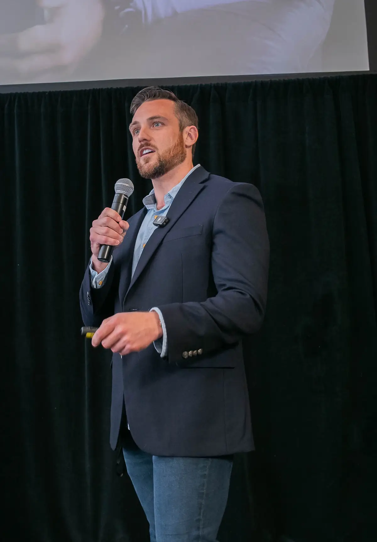 Rob Tracz speaking on stage at A2B Conference motivating entrepreneurs
