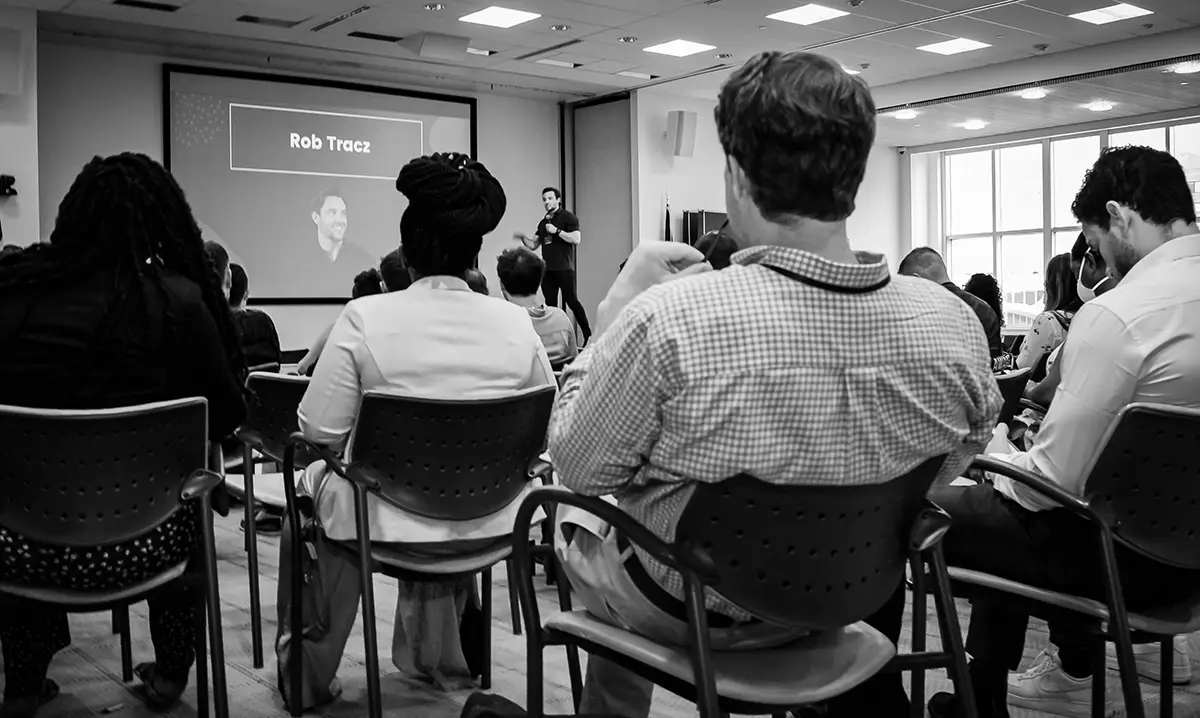 Rob Tracz on stage at the A2B personal development conference in stamford connecticut sharing his experiences and insights with an audience of high achieving entrepreneurs, small business owners, side hustlers and influencers